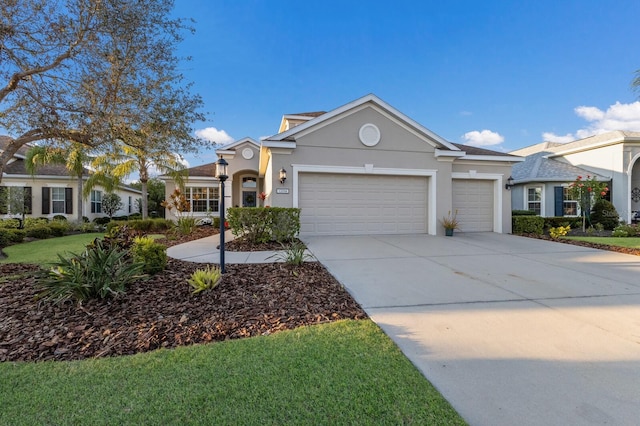 view of front of property with a front lawn, concrete driveway, an attached garage, and stucco siding