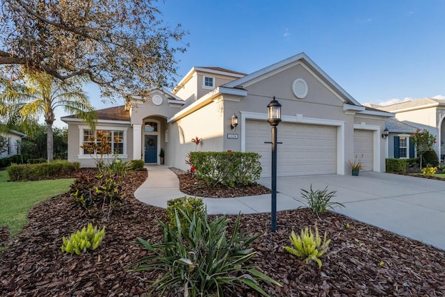 view of front of property featuring a garage, driveway, and stucco siding