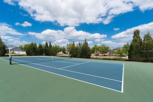 view of tennis court featuring fence