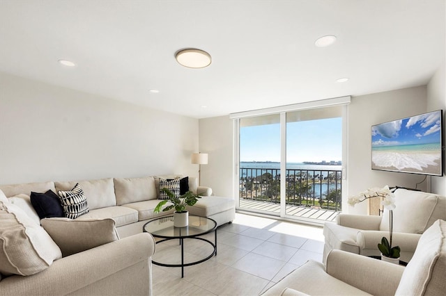 living area with expansive windows, recessed lighting, and light tile patterned floors