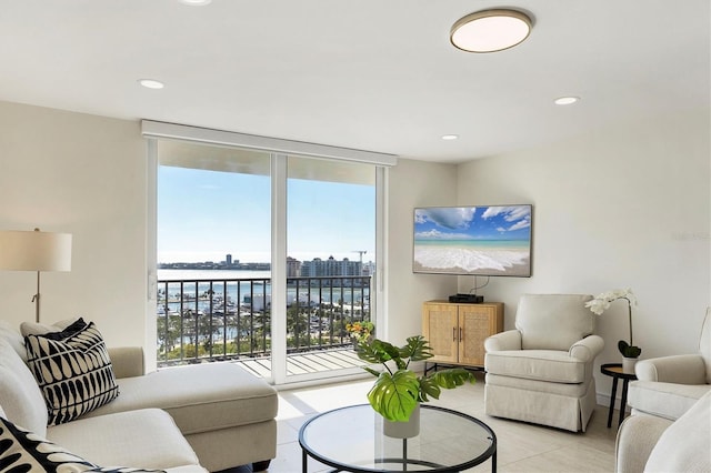 living area featuring light tile patterned floors, a wall of windows, and recessed lighting