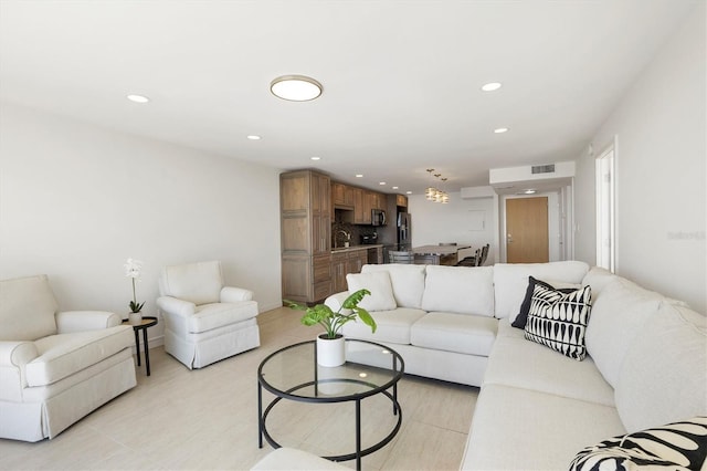 living room with recessed lighting and visible vents