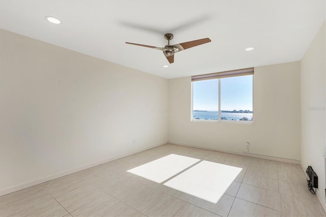 empty room featuring a ceiling fan, recessed lighting, baseboards, and light tile patterned floors