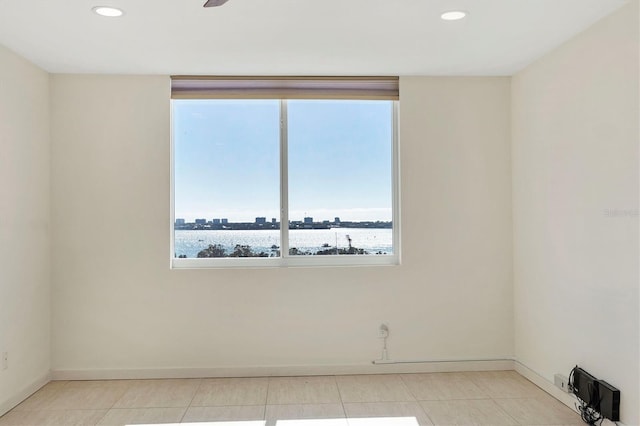 unfurnished room with baseboards, light tile patterned floors, and recessed lighting