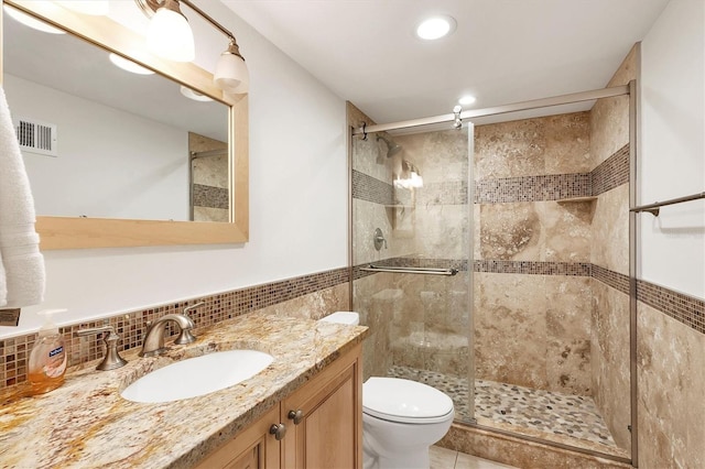 full bathroom with tasteful backsplash, recessed lighting, toilet, a shower stall, and vanity