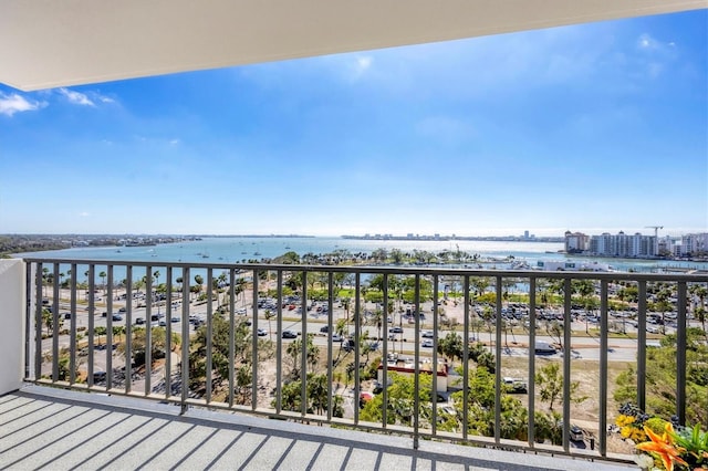 balcony featuring a water view and a city view