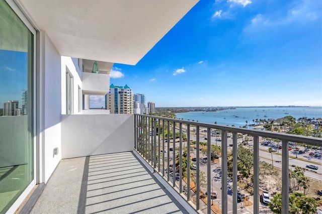 balcony featuring a view of city and a water view