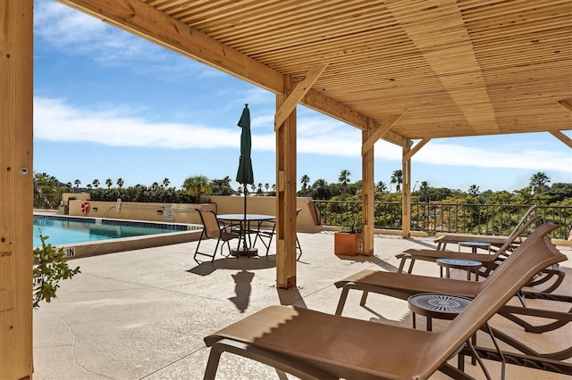 view of patio / terrace featuring outdoor dining space and a community pool