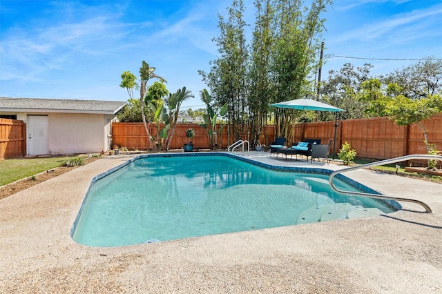 view of swimming pool featuring a patio area, a fenced backyard, and a fenced in pool