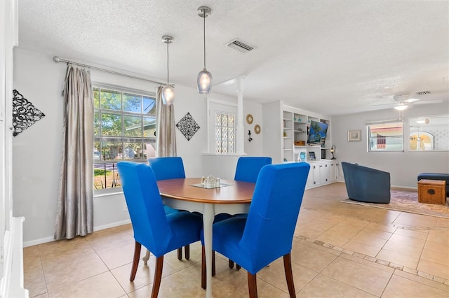 dining area featuring a textured ceiling, ceiling fan, light tile patterned flooring, and visible vents