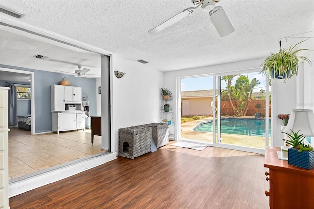 interior space with plenty of natural light, visible vents, and wood finished floors