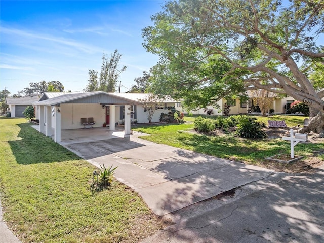 exterior space featuring a yard, an attached carport, and driveway