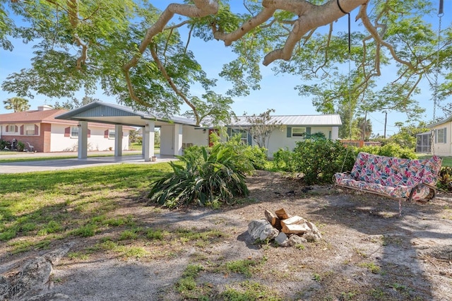 view of front of house with metal roof and a carport