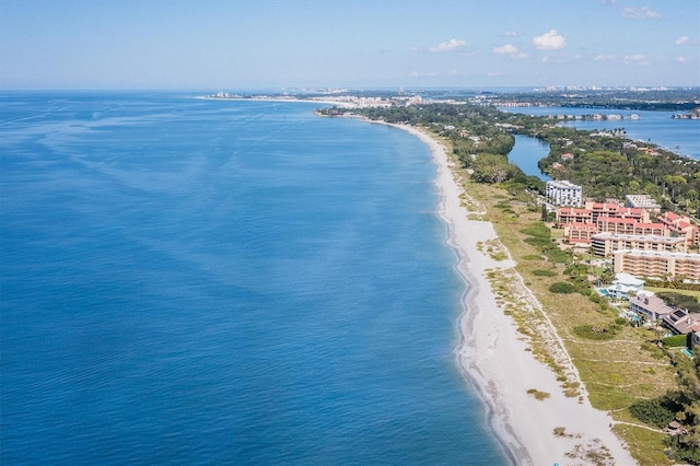 birds eye view of property with a water view and a beach view