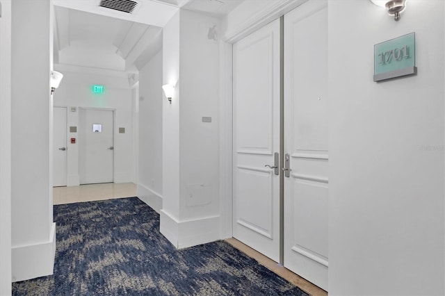 hall with tile patterned flooring and visible vents