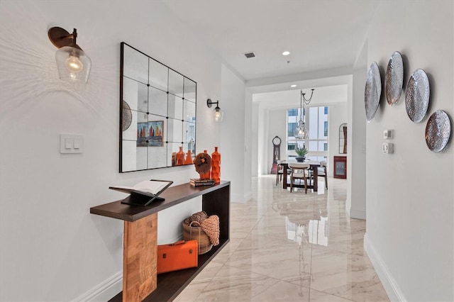 hallway with recessed lighting, marble finish floor, visible vents, and baseboards