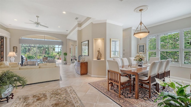 dining room with a healthy amount of sunlight, light tile patterned flooring, crown molding, and baseboards