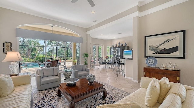 tiled living room with recessed lighting, visible vents, a ceiling fan, a sunroom, and baseboards