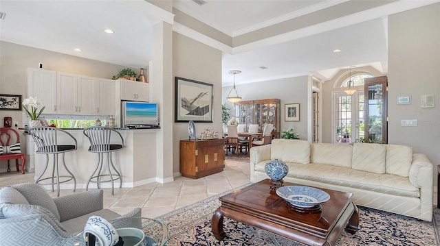 living area with light tile patterned floors, baseboards, ornamental molding, french doors, and recessed lighting