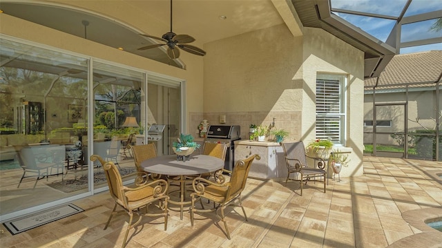 view of patio with a ceiling fan, outdoor dining space, a lanai, and a grill