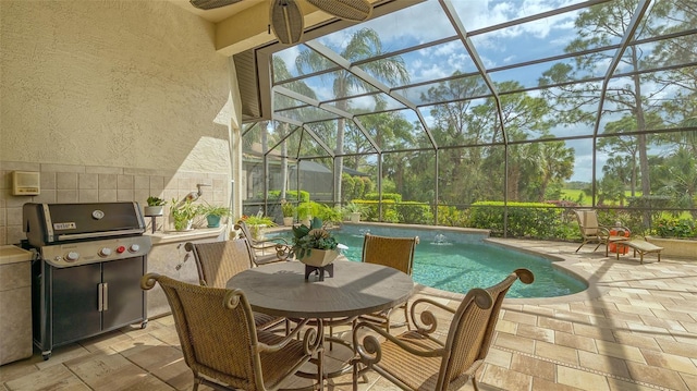 view of patio featuring exterior kitchen, a lanai, an outdoor pool, and grilling area