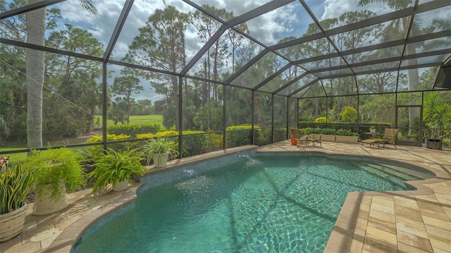 pool with a lanai and a patio area