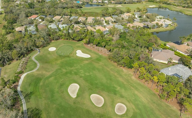 birds eye view of property with golf course view, a water view, and a residential view