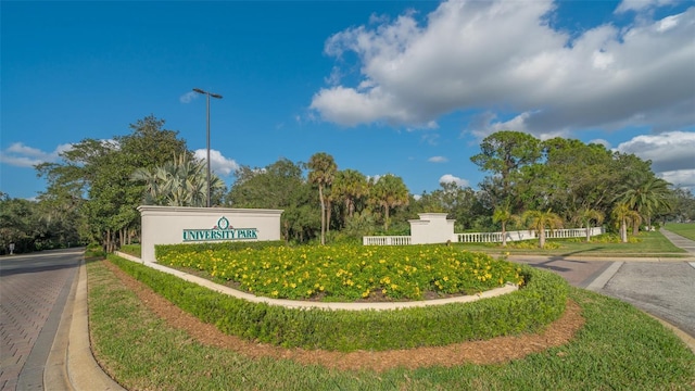 community sign featuring fence