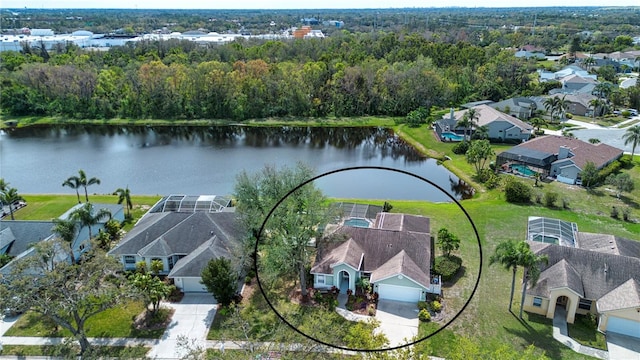 drone / aerial view with a water view and a residential view