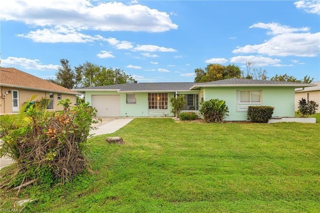 back of house featuring a garage, driveway, a lawn, and stucco siding