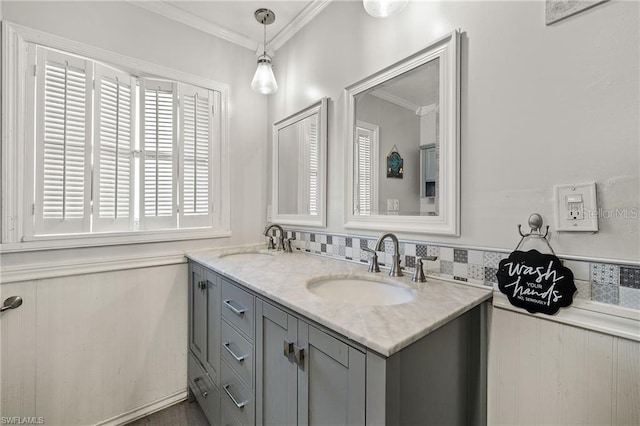 bathroom with double vanity, ornamental molding, and a sink