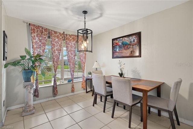 dining room with light tile patterned floors and baseboards