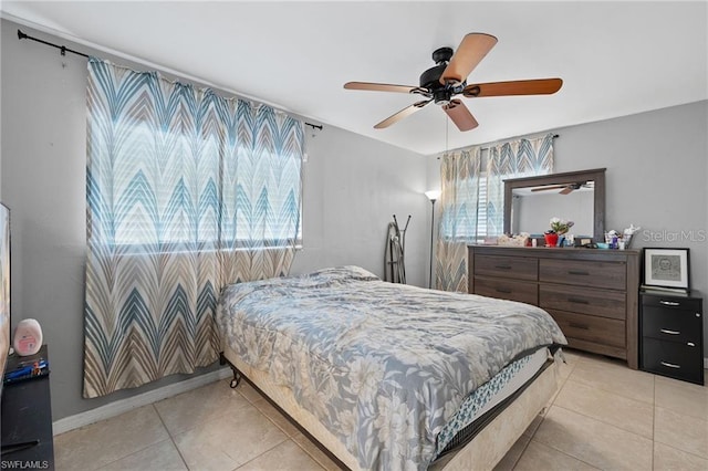 bedroom with multiple windows, a ceiling fan, and light tile patterned flooring