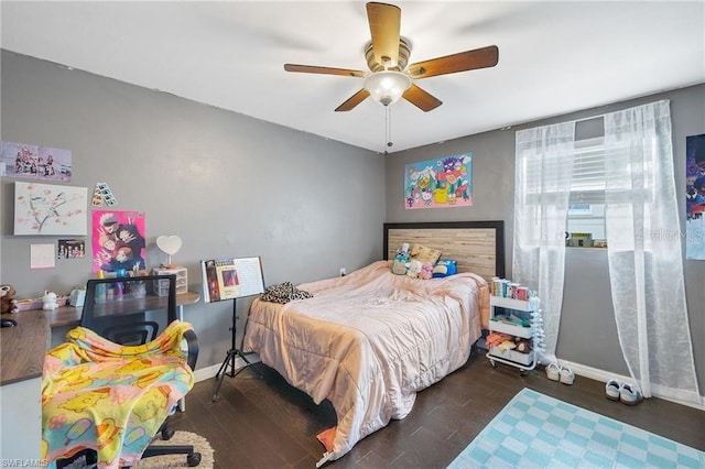 bedroom with a ceiling fan, baseboards, and wood finished floors