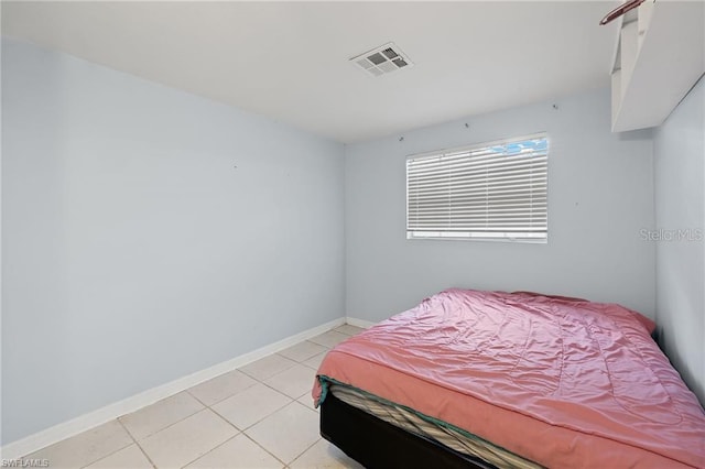 bedroom with light tile patterned floors, baseboards, and visible vents