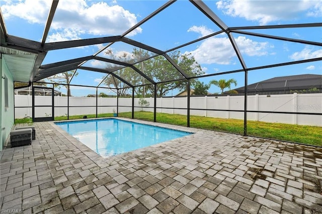 view of swimming pool featuring a lanai, fence private yard, a fenced in pool, and a patio