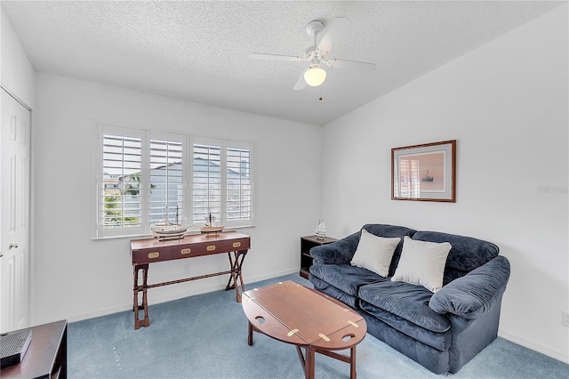 carpeted living room featuring a textured ceiling, a ceiling fan, and baseboards