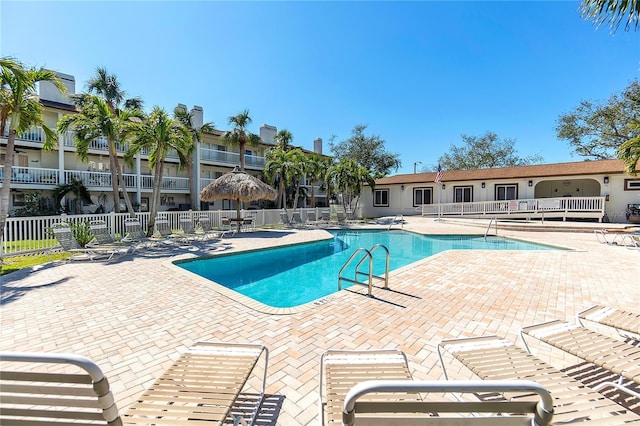 pool featuring a patio and fence