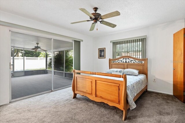 carpeted bedroom featuring access to outside, ceiling fan, and a textured ceiling