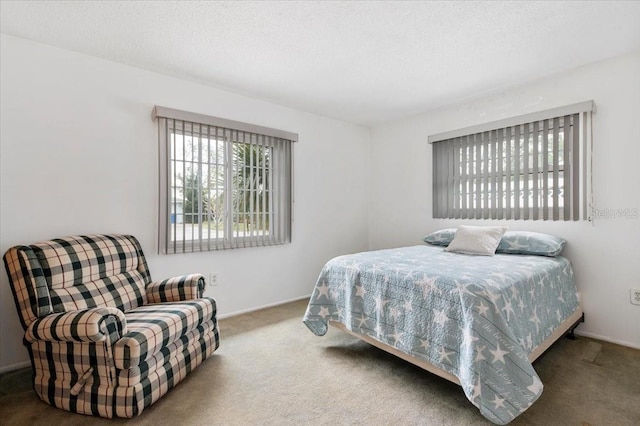 carpeted bedroom featuring a textured ceiling