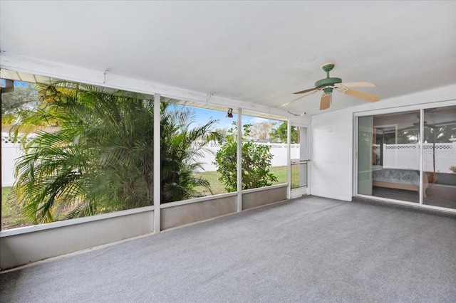 unfurnished sunroom featuring ceiling fan