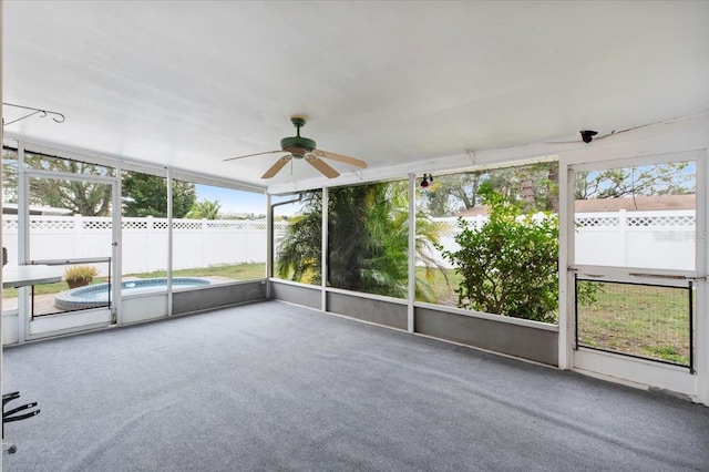 unfurnished sunroom featuring ceiling fan