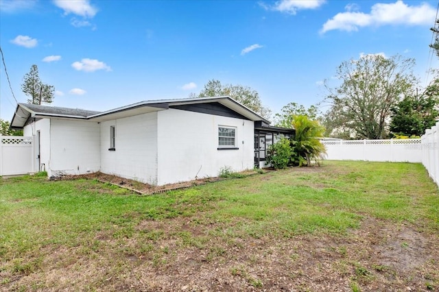 exterior space featuring a fenced backyard and a lawn