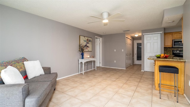 interior space with visible vents, backsplash, appliances with stainless steel finishes, ceiling fan, and baseboards