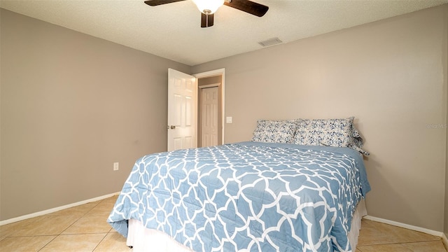 bedroom with baseboards, visible vents, a textured ceiling, and tile patterned floors