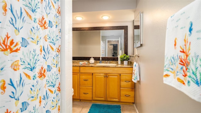 bathroom featuring curtained shower, vanity, and tile patterned floors