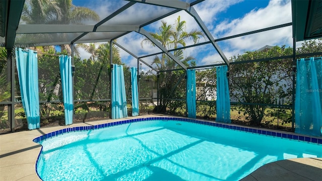 outdoor pool featuring glass enclosure