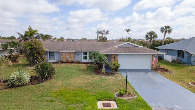 single story home featuring an attached garage, driveway, and a front lawn