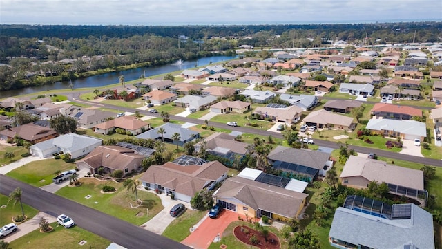 drone / aerial view with a residential view and a water view