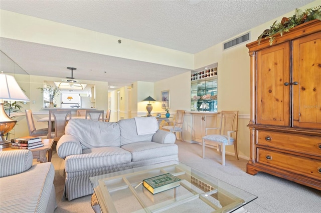 5740 Midnight Pass Rd Unit 402, Sarasota, FL 34242 - living room with light carpet, a textured ceiling, and visible vents